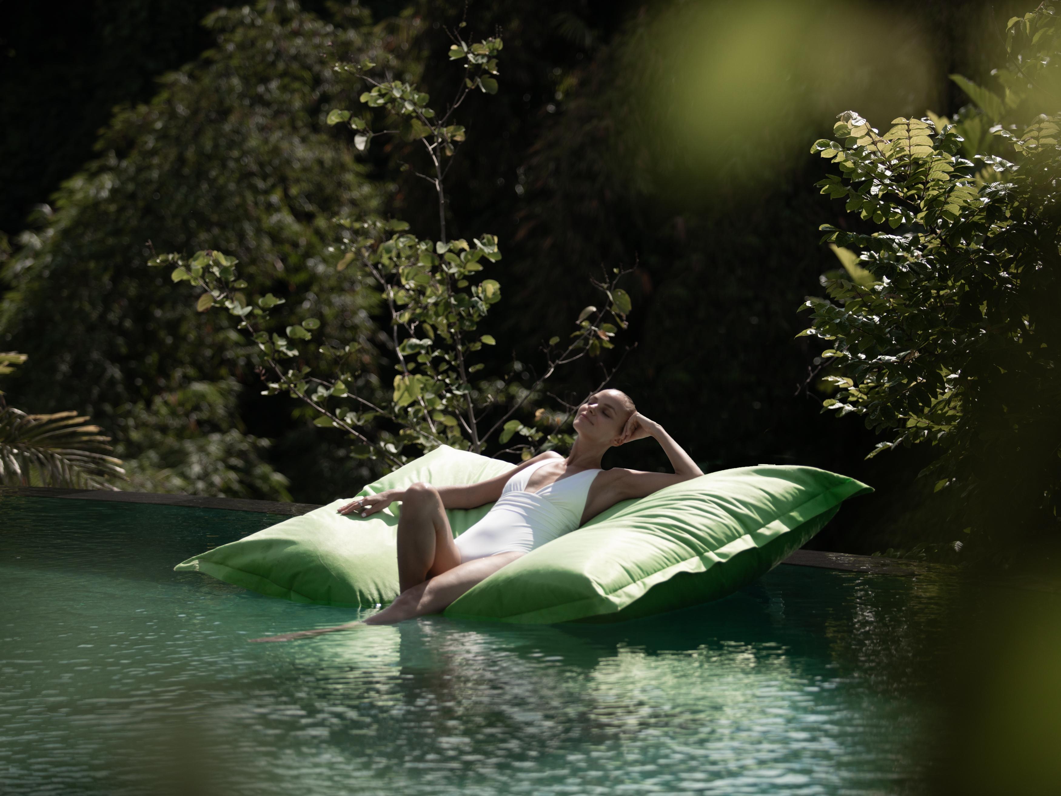 מלון אובוד Adiwana Suweta מראה חיצוני תמונה A woman relaxing on a floating bag